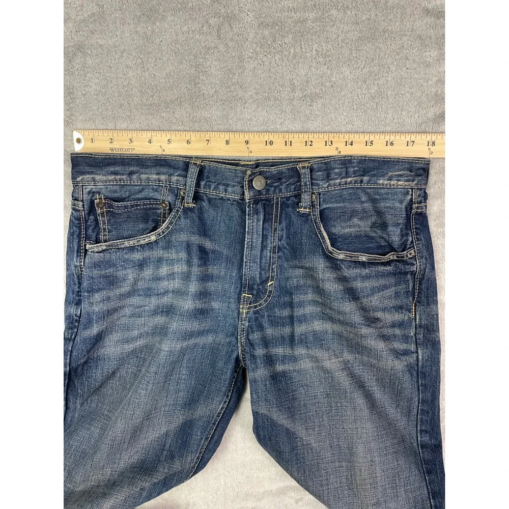American Eagle Jeans Men Size 34 Low Rise Boot Cut Blue Denim Distressed Casual